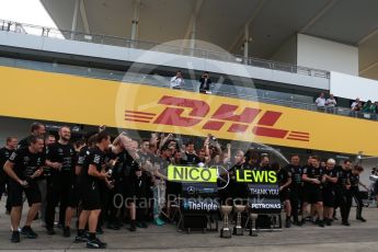 World © Octane Photographic Ltd. Mercedes AMG Petronas - The team celebrate behind the Nico Rosberg and Lewis Hamilton boards. Sunday 9th October 2016, F1 Japanese GP - World Constructors Champions 2016 celebrations. Suzuka Circuit, Suzuka, Japan. Digital Ref :1738LB2D4557